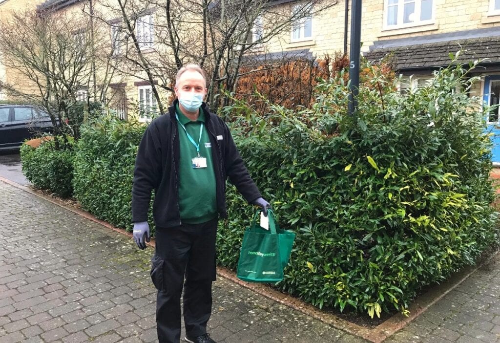 Home Library service volunteer delivers books